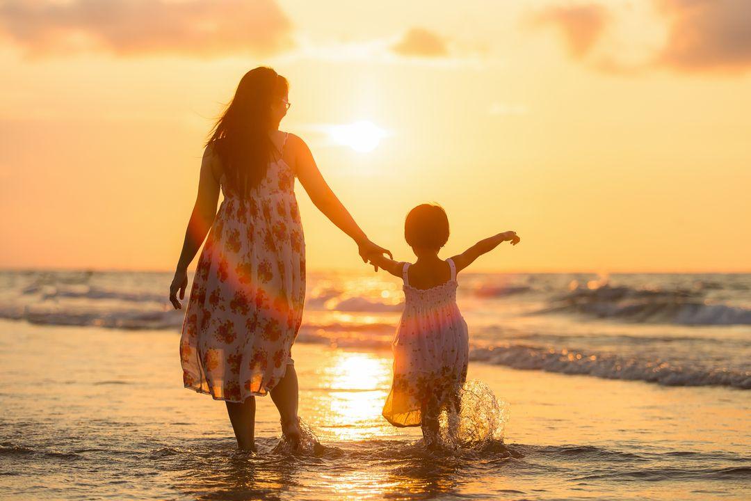 Mother and child walking toward the horizon symbolizing hope and healing
