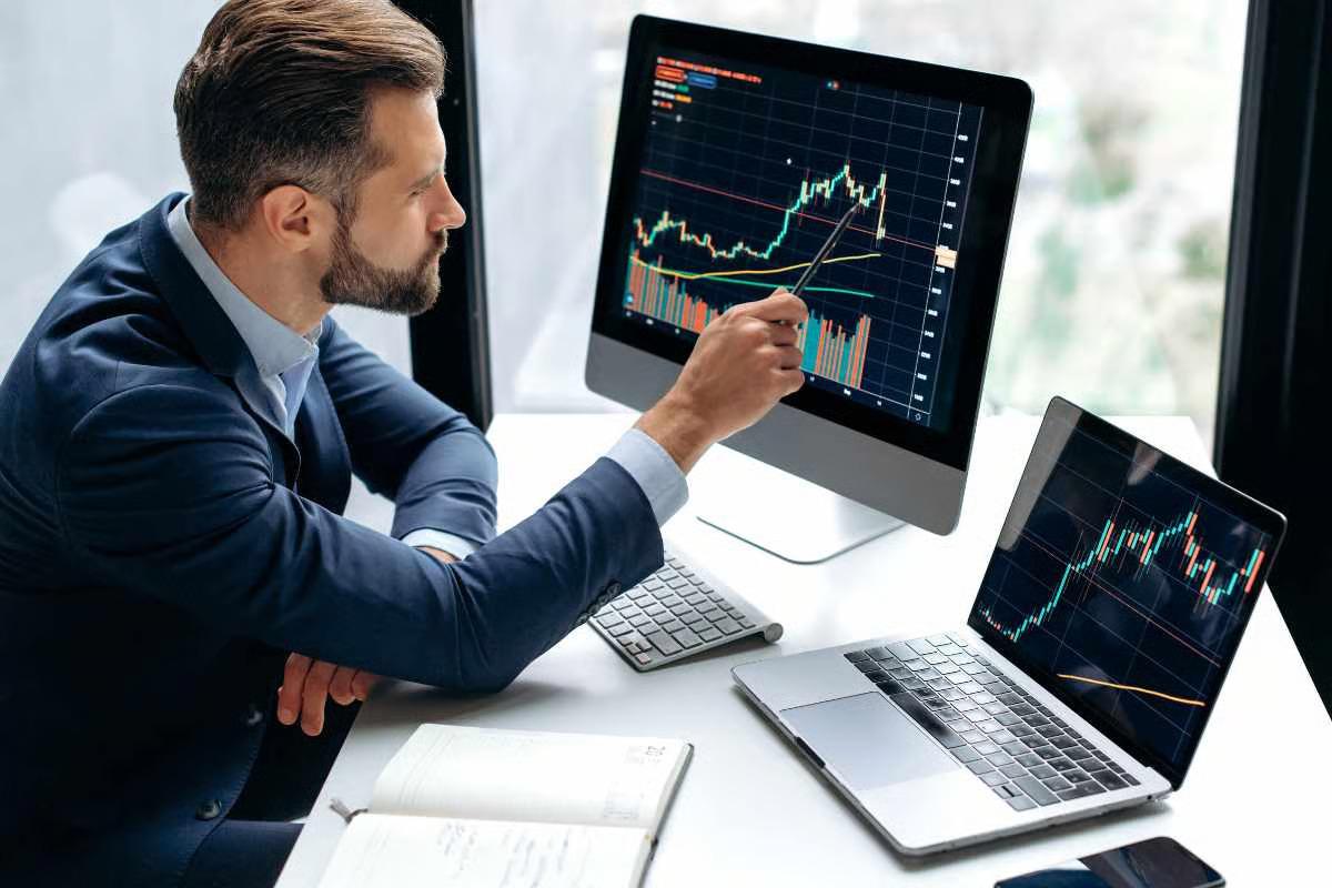 illustration of investor using online trading platform on laptop