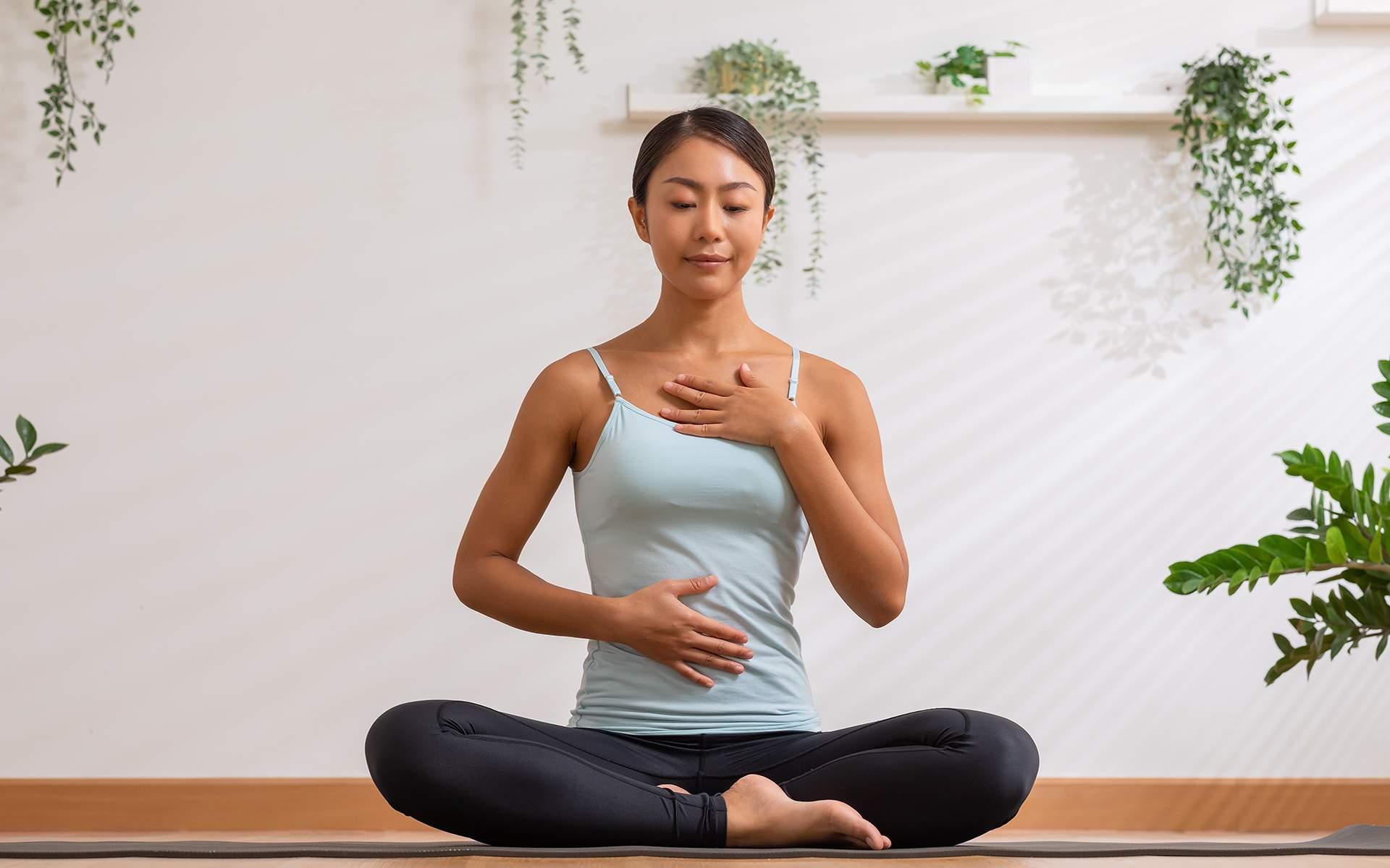 Beginner sitting comfortably in a quiet room practicing mindful breathing